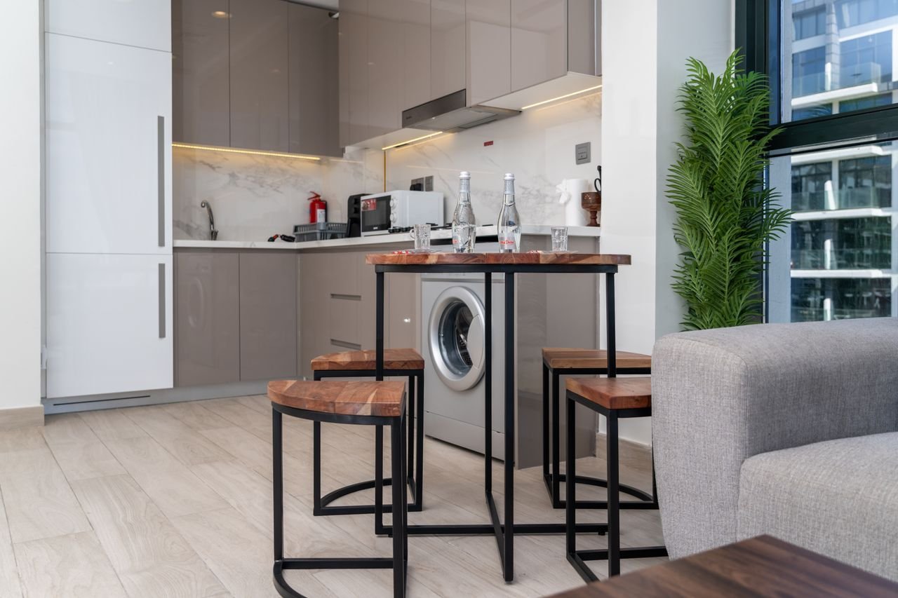 Stylish kitchen interior in a Dubai apartment with modern appliances and minimal decor.